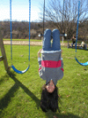 Photojournalist member playing on swings during free time